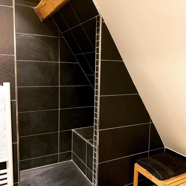 Salle de bain mansardée avec douche à l’italienne.